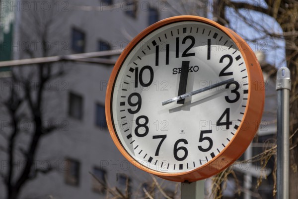 Urban design, close-up, orange Seiko clock, Ikebukuro Living Loop, Public Furniture, Higashiikebukuro, Toshima City, Tokyo, Japan