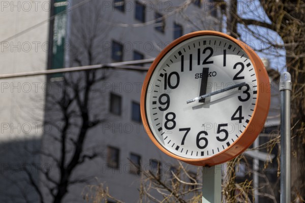 Urban design, close-up, orange Seiko clock, Ikebukuro Living Loop, Public Furniture, Higashiikebukuro, Toshima City, Tokyo, Japan