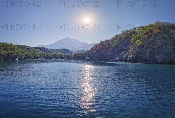 Wonderful Paradise bay of Camyuva, Kemer, Turkey. Scenery sea view to the coast with boats on the blue water. Summertime holiday seascape