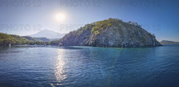 Wonderful Paradise bay of Camyuva, Kemer, Turkey. Scenery sea view to the coast with boats on the blue water. Summertime holiday seascape