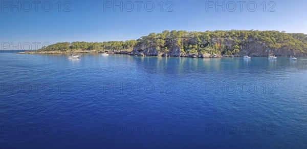 Wonderful Paradise bay of Camyuva, Kemer, Turkey. Scenery panoramic view of the coast with boats on the blue sea water. Summertime holiday seascape