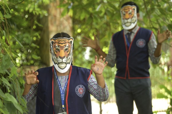 Agartala, Tripura, India, 29-07-2025: Students of NSS (National Service Scheme) unit from Mahatma Gandhi Memorial School wearing tiger masks during an event on Tiger Conservation on International Tiger day, organised by Sima Chakma, coordinator of MGM NSS UNIT at Agartala. International Tiger day is an annual celebration to raise awareness for tiger conservation, held annually on 29th July. Photo By-Abhisek Saha