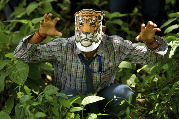 Agartala, Tripura, India, 29-07-2025: Students of NSS (National Service Scheme) unit from Mahatma Gandhi Memorial School wearing tiger masks during an event on Tiger Conservation on International Tiger day, organised by Sima Chakma, coordinator of MGM NSS UNIT at Agartala. International Tiger day is an annual celebration to raise awareness for tiger conservation, held annually on 29th July. Photo By-Abhisek Saha