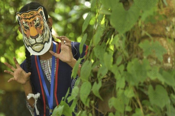 Agartala, Tripura, India, 29-07-2025: Students of NSS (National Service Scheme) unit from Mahatma Gandhi Memorial School wearing tiger masks during an event on Tiger Conservation on International Tiger day, organised by Sima Chakma, coordinator of MGM NSS UNIT at Agartala. International Tiger day is an annual celebration to raise awareness for tiger conservation, held annually on 29th July. Photo By-Abhisek Saha