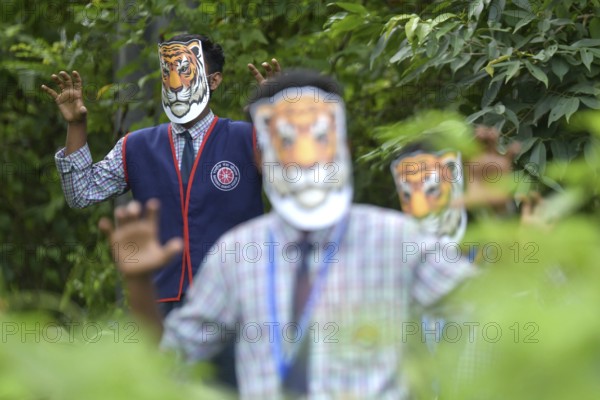 Agartala, Tripura, India, 29-07-2025: Students of NSS (National Service Scheme) unit from Mahatma Gandhi Memorial School wearing tiger masks during an event on Tiger Conservation on International Tiger day, organised by Sima Chakma, coordinator of MGM NSS UNIT at Agartala. International Tiger day is an annual celebration to raise awareness for tiger conservation, held annually on 29th July. Photo By-Abhisek Saha