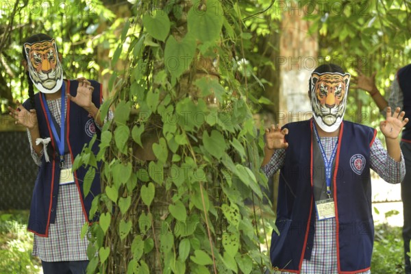 Agartala, Tripura, India, 29-07-2025: Students of NSS (National Service Scheme) unit from Mahatma Gandhi Memorial School wearing tiger masks during an event on Tiger Conservation on International Tiger day, organised by Sima Chakma, coordinator of MGM NSS UNIT at Agartala. International Tiger day is an annual celebration to raise awareness for tiger conservation, held annually on 29th July. Photo By-Abhisek Saha