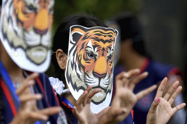 Agartala, Tripura, India, 29-07-2025: Students of NSS (National Service Scheme) unit from Mahatma Gandhi Memorial School wearing tiger masks during an event on Tiger Conservation on International Tiger day, organised by Sima Chakma, coordinator of MGM NSS UNIT at Agartala. International Tiger day is an annual celebration to raise awareness for tiger conservation, held annually on 29th July. Photo By-Abhisek Saha