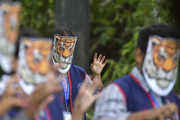 Agartala, Tripura, India, 29-07-2025: Students of NSS (National Service Scheme) unit from Mahatma Gandhi Memorial School wearing tiger masks during an event on Tiger Conservation on International Tiger day, organised by Sima Chakma, coordinator of MGM NSS UNIT at Agartala. International Tiger day is an annual celebration to raise awareness for tiger conservation, held annually on 29th July. Photo By-Abhisek Saha