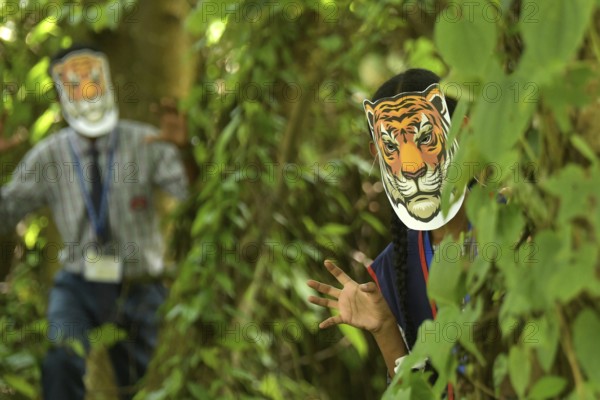 Agartala, Tripura, India, 29-07-2025: Students of NSS (National Service Scheme) unit from Mahatma Gandhi Memorial School wearing tiger masks during an event on Tiger Conservation on International Tiger day, organised by Sima Chakma, coordinator of MGM NSS UNIT at Agartala. International Tiger day is an annual celebration to raise awareness for tiger conservation, held annually on 29th July. Photo By-Abhisek Saha