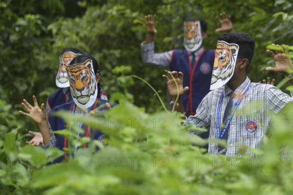 Agartala, Tripura, India, 29-07-2025: Students of NSS (National Service Scheme) unit from Mahatma Gandhi Memorial School wearing tiger masks during an event on Tiger Conservation on International Tiger day, organised by Sima Chakma, coordinator of MGM NSS UNIT at Agartala. International Tiger day is an annual celebration to raise awareness for tiger conservation, held annually on 29th July. Photo By-Abhisek Saha