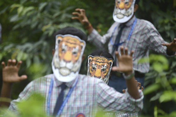 Agartala, Tripura, India, 29-07-2025: Students of NSS (National Service Scheme) unit from Mahatma Gandhi Memorial School wearing tiger masks during an event on Tiger Conservation on International Tiger day, organised by Sima Chakma, coordinator of MGM NSS UNIT at Agartala. International Tiger day is an annual celebration to raise awareness for tiger conservation, held annually on 29th July. Photo By-Abhisek Saha