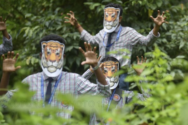 Agartala, Tripura, India, 29-07-2025: Students of NSS (National Service Scheme) unit from Mahatma Gandhi Memorial School wearing tiger masks during an event on Tiger Conservation on International Tiger day, organised by Sima Chakma, coordinator of MGM NSS UNIT at Agartala. International Tiger day is an annual celebration to raise awareness for tiger conservation, held annually on 29th July. Photo By-Abhisek Saha