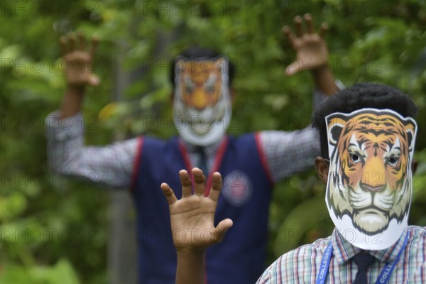 Agartala, Tripura, India, 29-07-2025: Students of NSS (National Service Scheme) unit from Mahatma Gandhi Memorial School wearing tiger masks during an event on Tiger Conservation on International Tiger day, organised by Sima Chakma, coordinator of MGM NSS UNIT at Agartala. International Tiger day is an annual celebration to raise awareness for tiger conservation, held annually on 29th July. Photo By-Abhisek Saha