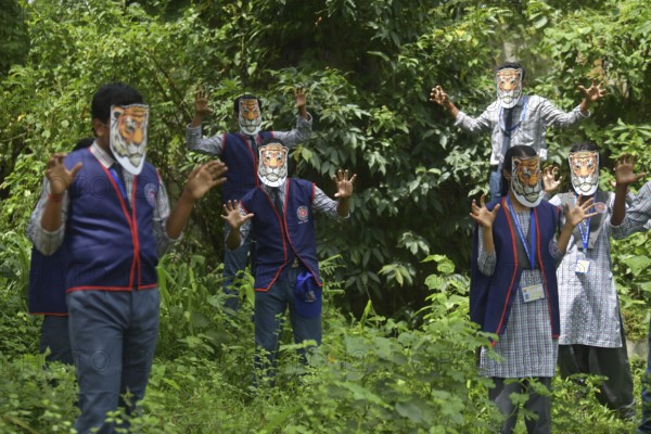 Agartala, Tripura, India, 29-07-2025: Students of NSS (National Service Scheme) unit from Mahatma Gandhi Memorial School wearing tiger masks during an event on Tiger Conservation on International Tiger day, organised by Sima Chakma, coordinator of MGM NSS UNIT at Agartala. International Tiger day is an annual celebration to raise awareness for tiger conservation, held annually on 29th July. Photo By-Abhisek Saha
