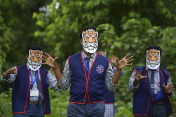 Agartala, Tripura, India, 29-07-2025: Students of NSS (National Service Scheme) unit from Mahatma Gandhi Memorial School wearing tiger masks during an event on Tiger Conservation on International Tiger day, organised by Sima Chakma, coordinator of MGM NSS UNIT at Agartala. International Tiger day is an annual celebration to raise awareness for tiger conservation, held annually on 29th July. Photo By-Abhisek Saha