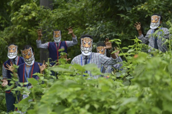 Agartala, Tripura, India, 29-07-2025: Students of NSS (National Service Scheme) unit from Mahatma Gandhi Memorial School wearing tiger masks during an event on Tiger Conservation on International Tiger day, organised by Sima Chakma, coordinator of MGM NSS UNIT at Agartala. International Tiger day is an annual celebration to raise awareness for tiger conservation, held annually on 29th July. Photo By-Abhisek Saha