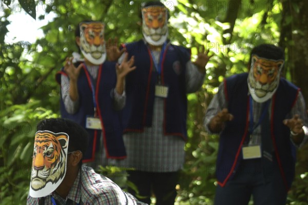Agartala, Tripura, India, 29-07-2025: Students of NSS (National Service Scheme) unit from Mahatma Gandhi Memorial School wearing tiger masks during an event on Tiger Conservation on International Tiger day, organised by Sima Chakma, coordinator of MGM NSS UNIT at Agartala. International Tiger day is an annual celebration to raise awareness for tiger conservation, held annually on 29th July. Photo By-Abhisek Saha