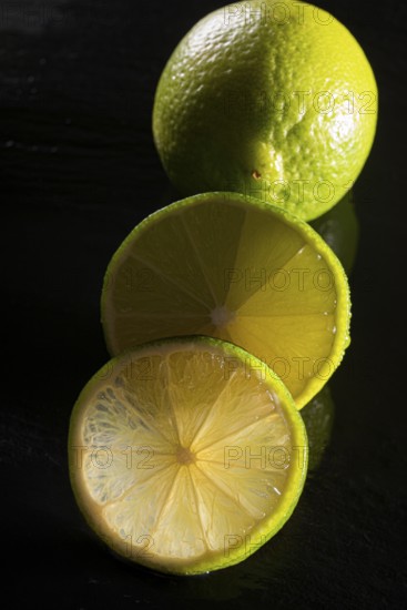 Limes on a black stone slab