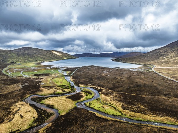 View over Eas a' Bhradain Waterfall from drone, Red Cuillin mountains, Loch Ainort, Isle of Skye, Scotland, UK