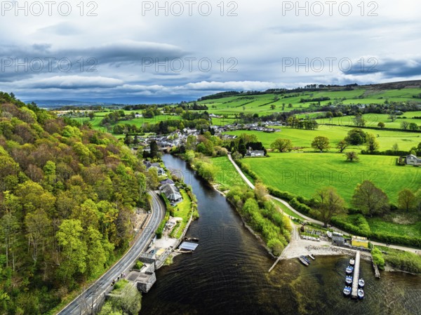 Farms and mountains over Ullswater Lake from drone, Pooley Bridge, Lake District National Park, Cumbria, England, United Kingdom