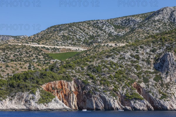 View from the sea to the red rocks, island of Hvar, Dalmatia, Croatia