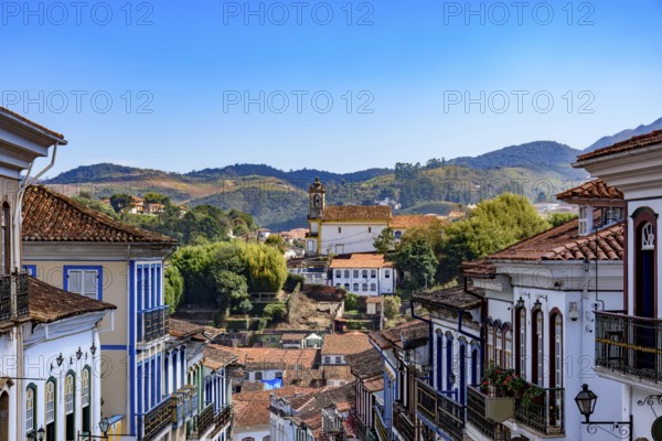 Houses and church in the historic city of Ouro Preto with the mountains in the background, Ouro Preto, Minas Gerais, Brazil