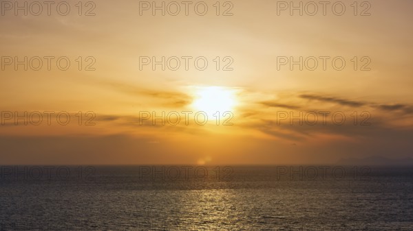 Evening sun behind Cirrus, golden sunset by the sea, Oia, Thira, Santorini, Cyclades, Greece
