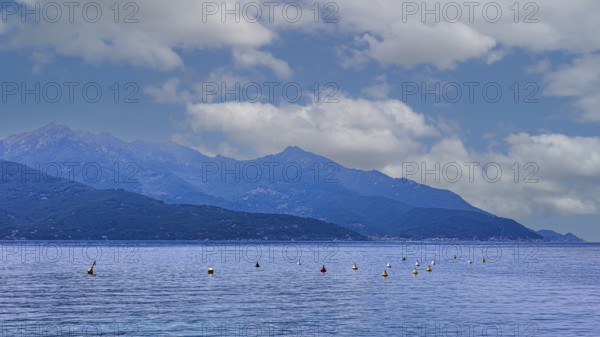 Clouds over the Golfo di Viticcio, in the background the mountains of Monte Capanne, Elba Island, Tuscan Archipelago National Park, Tuscany, Italy