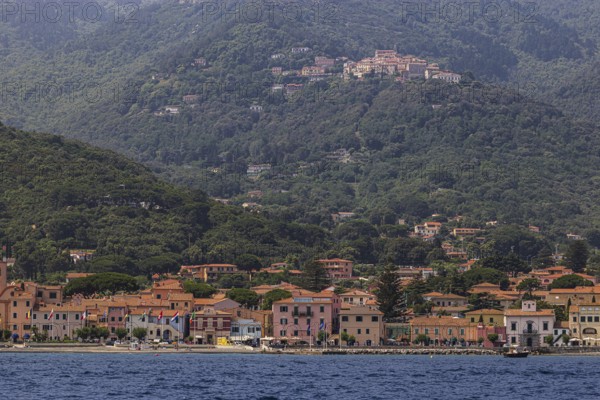 The harbour of Marziana Marina, behind the mountain village of Poggio, Elba Island, Tuscan Archipelago National Park, Tuscany, Italy