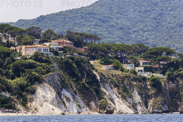 Holiday homes above rocky cliffs, Portoferraio, Elba Island, Tuscan Archipelago National Park, Tuscany, Italy