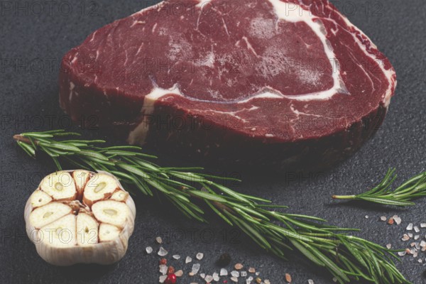 Raw steak, beef steak, rib eye steak, on the table, top view, no people, on a dark background
