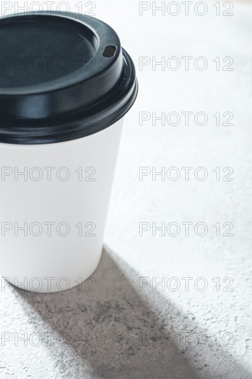 Coffee cup on the table, minimalistic design, disposable tableware, daylight