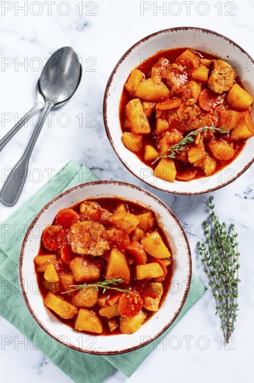 Meat goulash with potatoes and carrots, sweet peppers, in a saucepan, top view, traditional Hungarian soup, homemade, no people