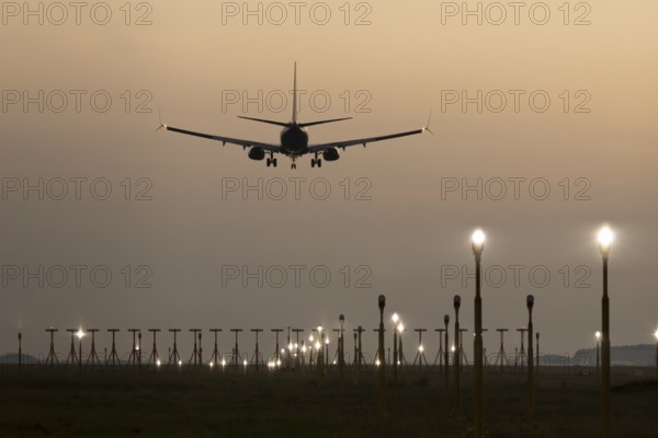 Boeing 737 jet passenger aircraft of Ryanair airlines in flight landing at sunset at London Stansted airport, Essex, England, United Kingdom