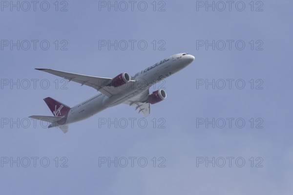 Boeing 787-9 Dreamliner jet passenger aircraft of Virgin Atlantic airlines in flight in a blue sky, England, United Kingdom