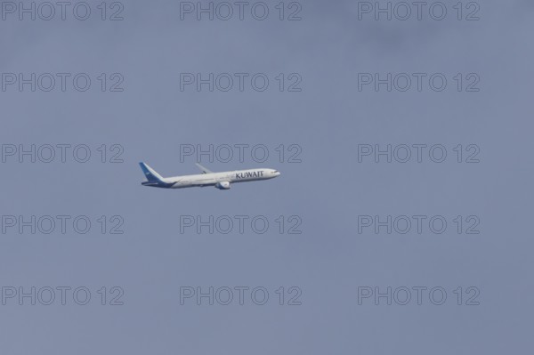 Boeing 777 jet passenger aircraft of Kuwait airlines in flight in a blue sky, England, United Kingdom