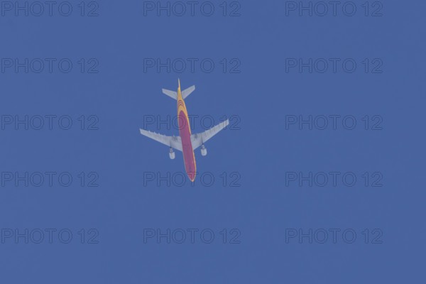 Boeing 767 jet aircraft of DHL cargo airlines in flight in a blue sky, England, United Kingdom