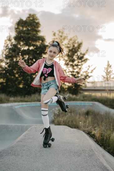 Girl with roller skates on a skating rink