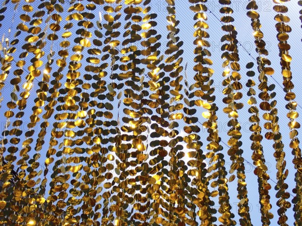 Golden garlands shine in the sun as a background, North Rhine-Westphalia, Germany