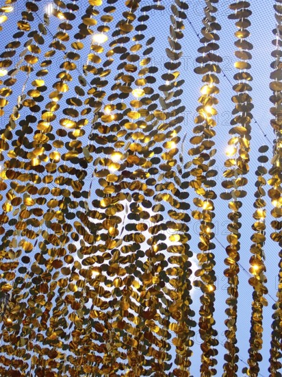 Golden garlands shine in the sun as a background, North Rhine-Westphalia, Germany
