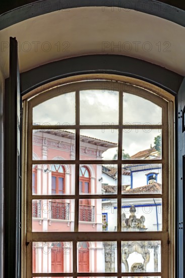 View of the city of Ouro Preto through an old window in a colonial mansion, Ouro Preto, Minas Gerais, Brazil