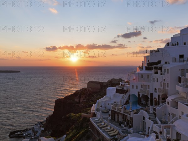 Holiday homes on the edge of the caldera overlooking the sea, sunset, Oia, Thira, Santorini, Cyclades, Greece