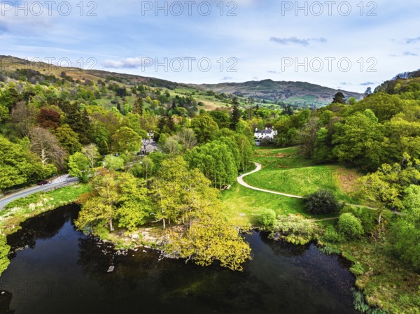 Farms and Mountains over road A591 from a drone, Grasmere Lake, Grasmere, Ambleside, Lake District, Westmorland, Cumbria, UK