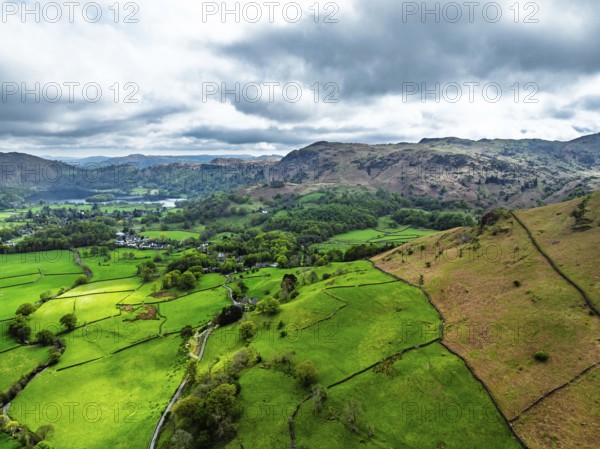 Farms and Mountains over road A591 from a drone, Grasmere Lake, Grasmere, Ambleside, Lake District, Westmorland, Cumbria, UK