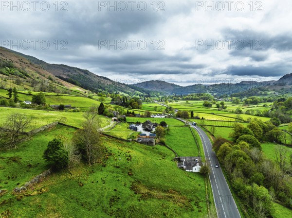 Farms and Mountains over road A591 from a drone, Grasmere Lake, Grasmere, Ambleside, Lake District, Westmorland, Cumbria, UK