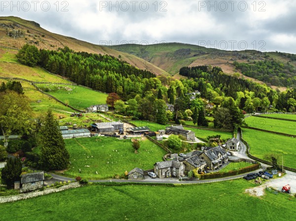 Farms and Mountains over road A591 from a drone, Grasmere Lake, Grasmere, Ambleside, Lake District, Westmorland, Cumbria, UK