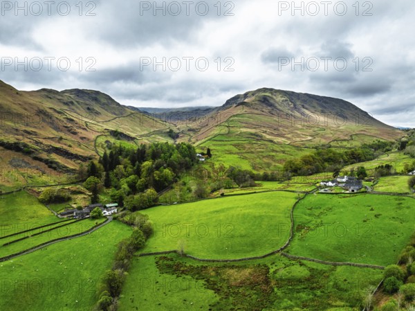 Farms and Mountains over road A591 from a drone, Grasmere Lake, Grasmere, Ambleside, Lake District, Westmorland, Cumbria, UK