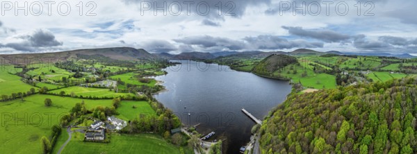 Panorama of Farms and mountains over Ullswater Lake from drone, Pooley Bridge, Lake District National Park, Cumbria, England, United Kingdom