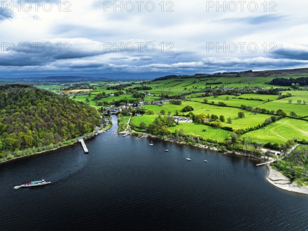 Farms and mountains over Ullswater Lake from drone, Pooley Bridge, Lake District National Park, Cumbria, England, United Kingdom