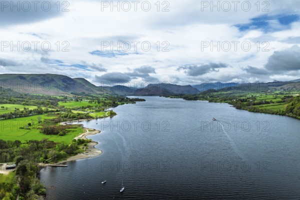 Farms and mountains over Ullswater Lake from drone, Pooley Bridge, Lake District National Park, Cumbria, England, United Kingdom